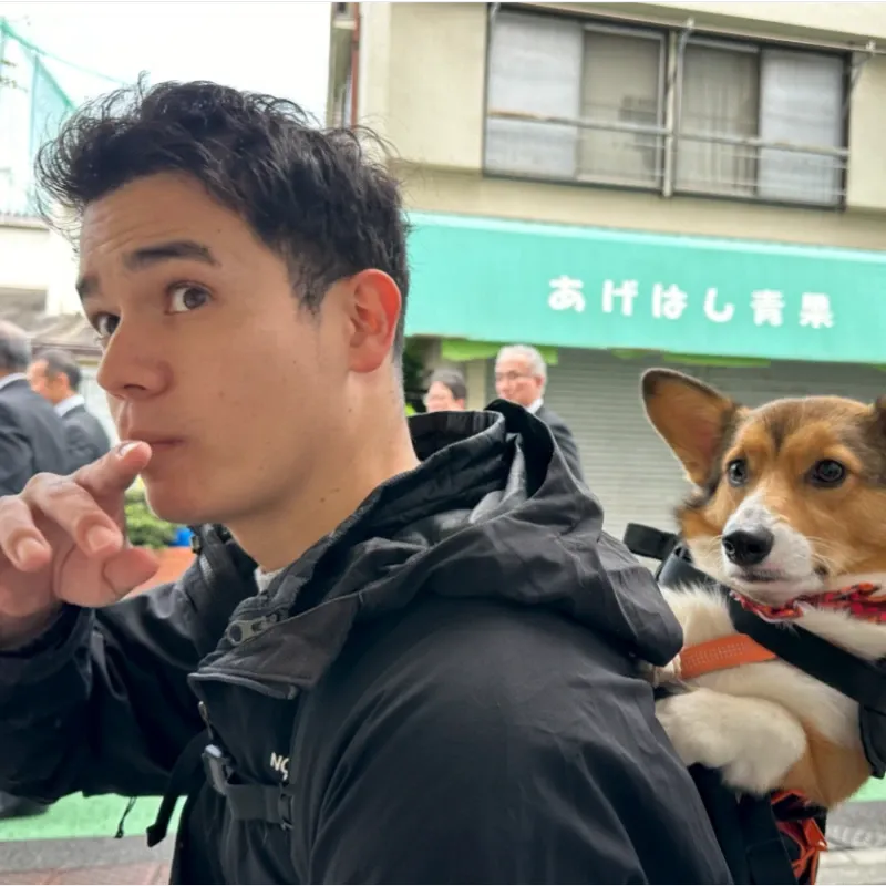 Shoin Wolfe with a corgi in a backpack in Tokyo